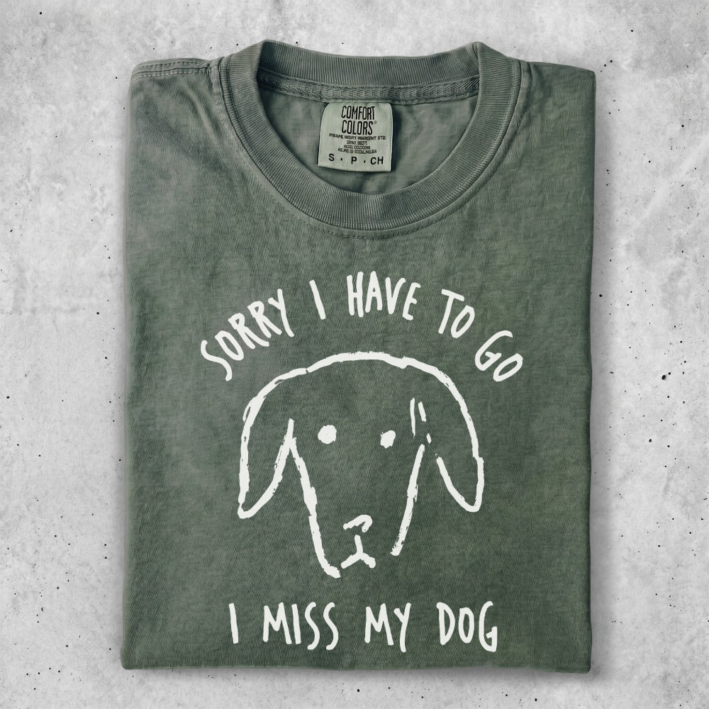 Green t-shirt with "Sorry I Have To Go I Miss My Dog" and dog graphic.