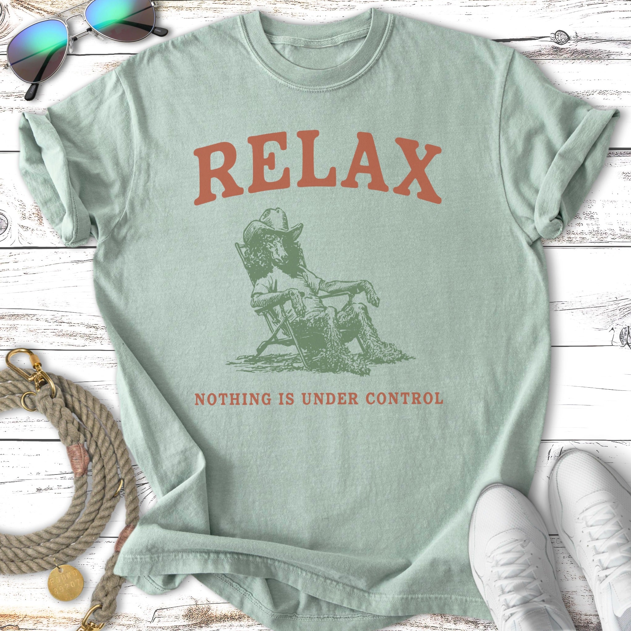 Pale green t-shirt with "RELAX NOTHING IS UNDER CONTROL" text.