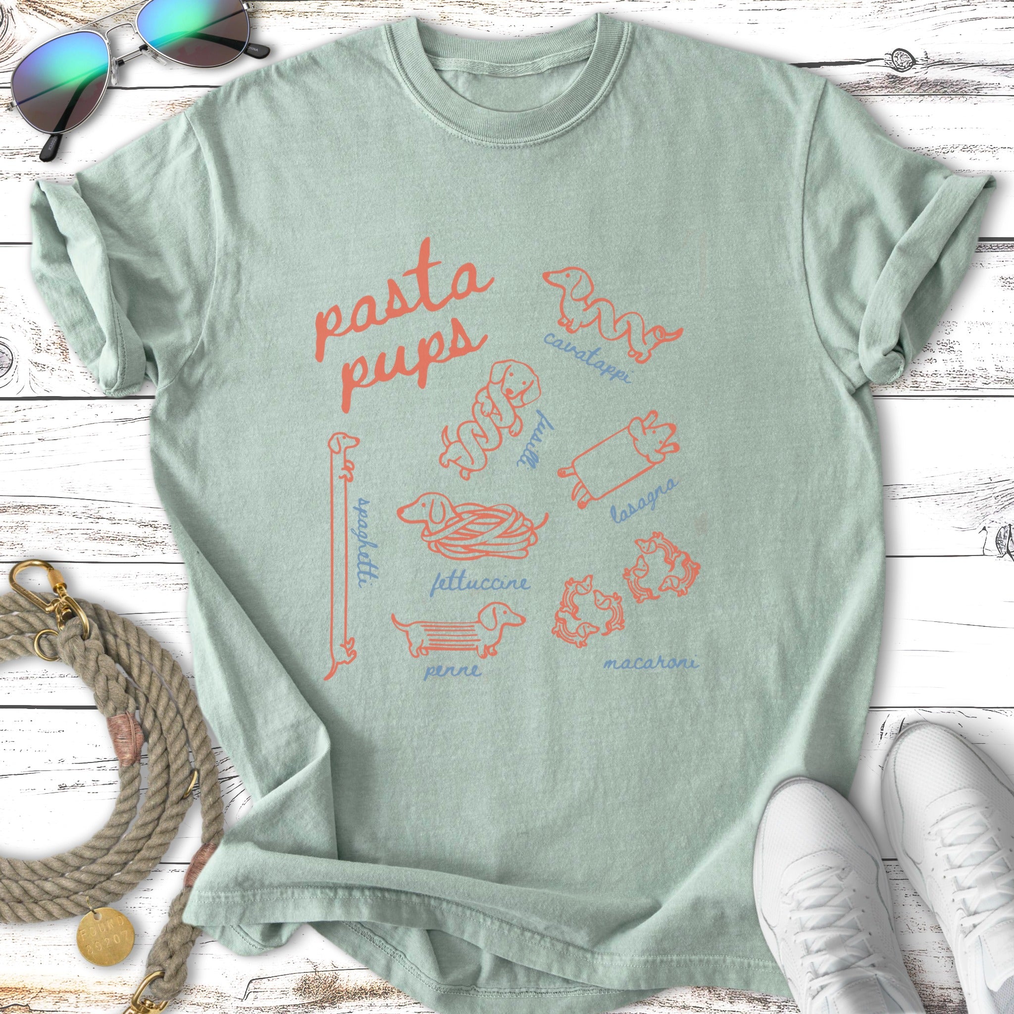Light green t-shirt with cartoon dog breeds labeled as pasta names.