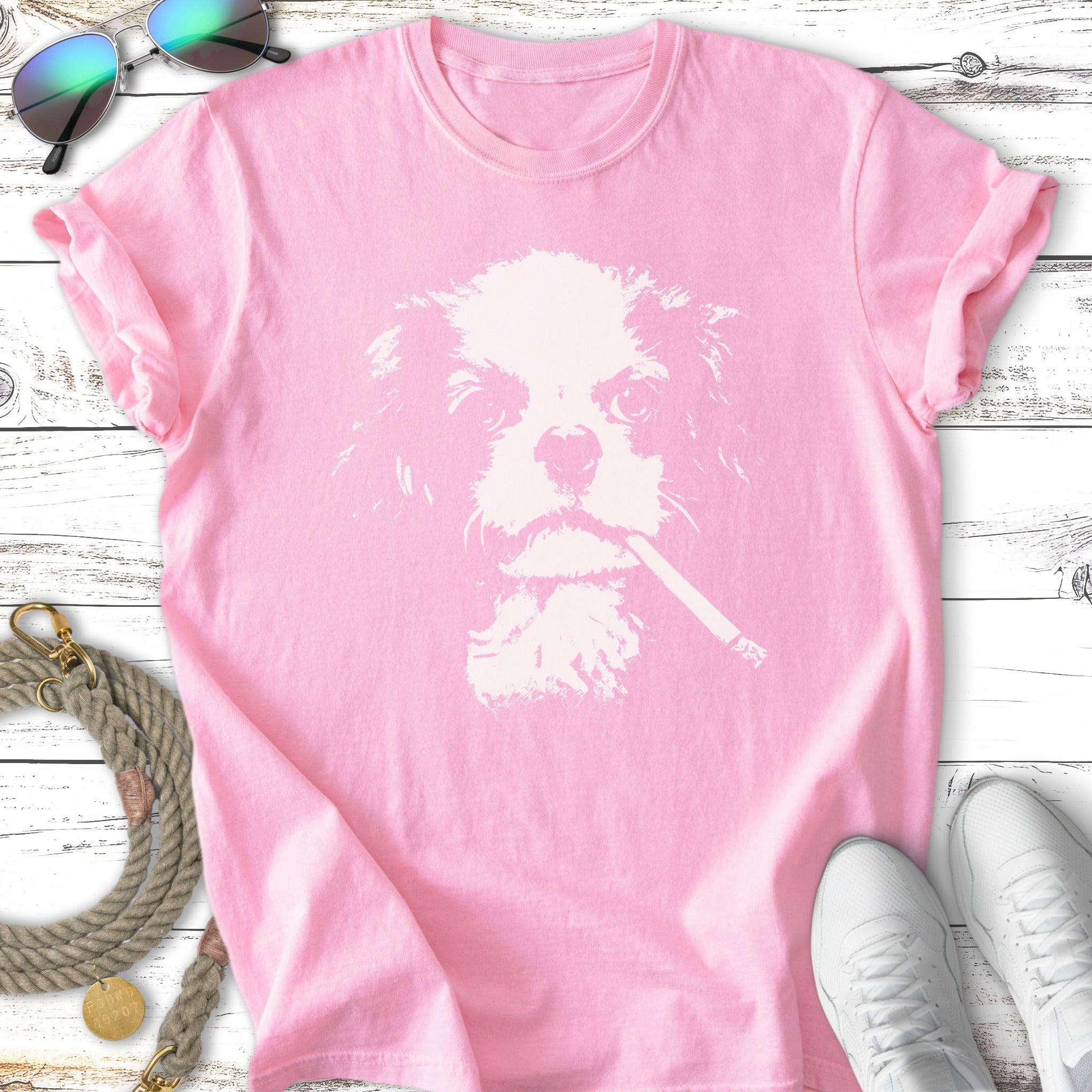 Pink t-shirt with white silhouette of dog wearing cigarette.