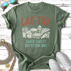 Green t-shirt with "LAB TAX SNACK SAFETY INSPECTION UNIT" and snack illustrations.