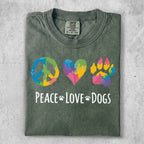 Green t-shirt with peace, heart, and paw print icons and "Peace Love Dogs" text.