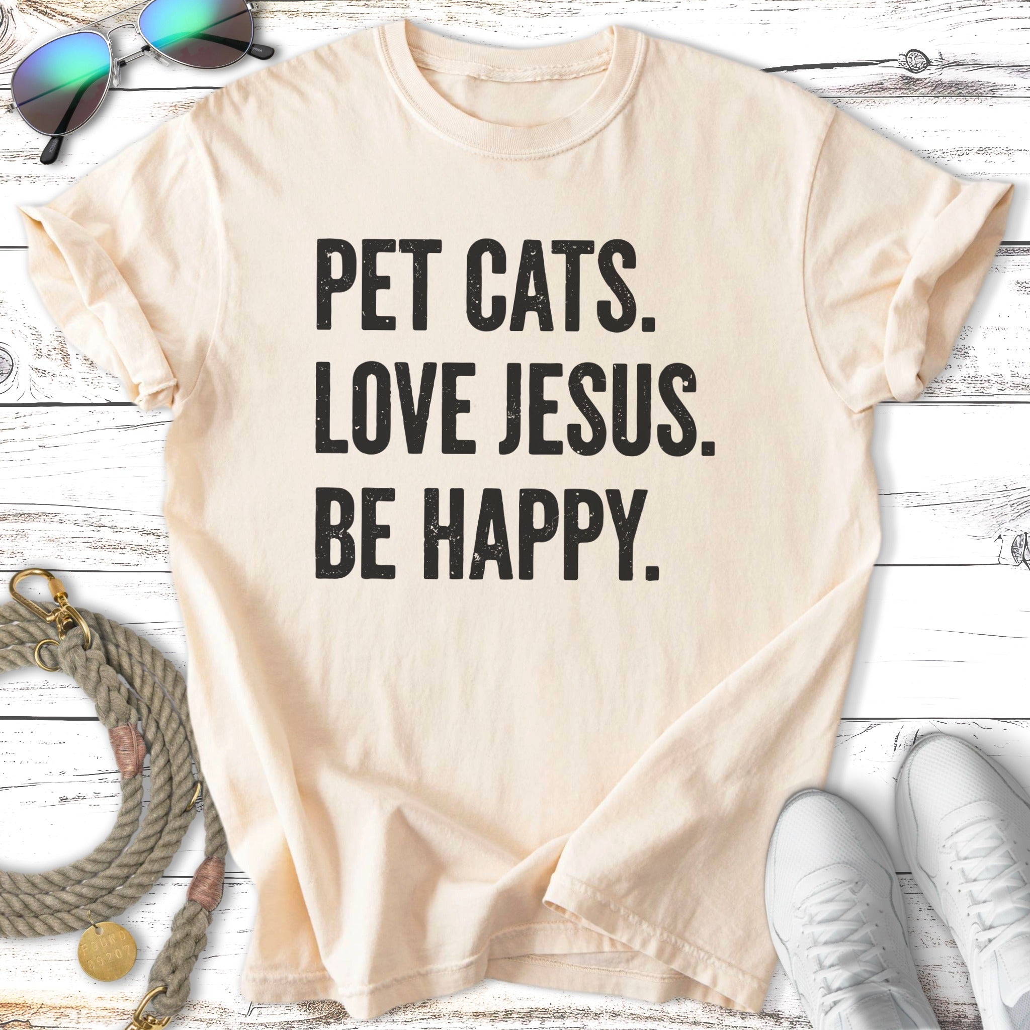 Cream t-shirt with "PET CATS. LOVE JESUS. BE HAPPY." text.