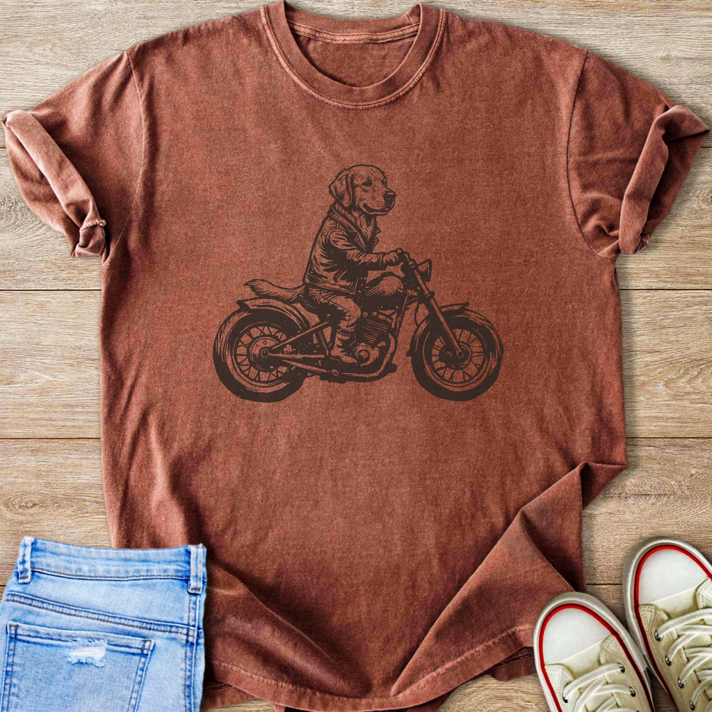 Dog wearing a jacket riding a motorcycle graphic on a rust-colored t-shirt.