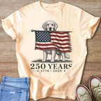 Golden retriever holds torn American flag with text "250 YEARS 1776-2026".