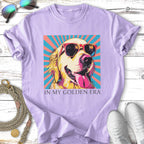 Golden Retriever wearing sunglasses against a colorful striped background, text reads "IN MY GOLDEN ERA".