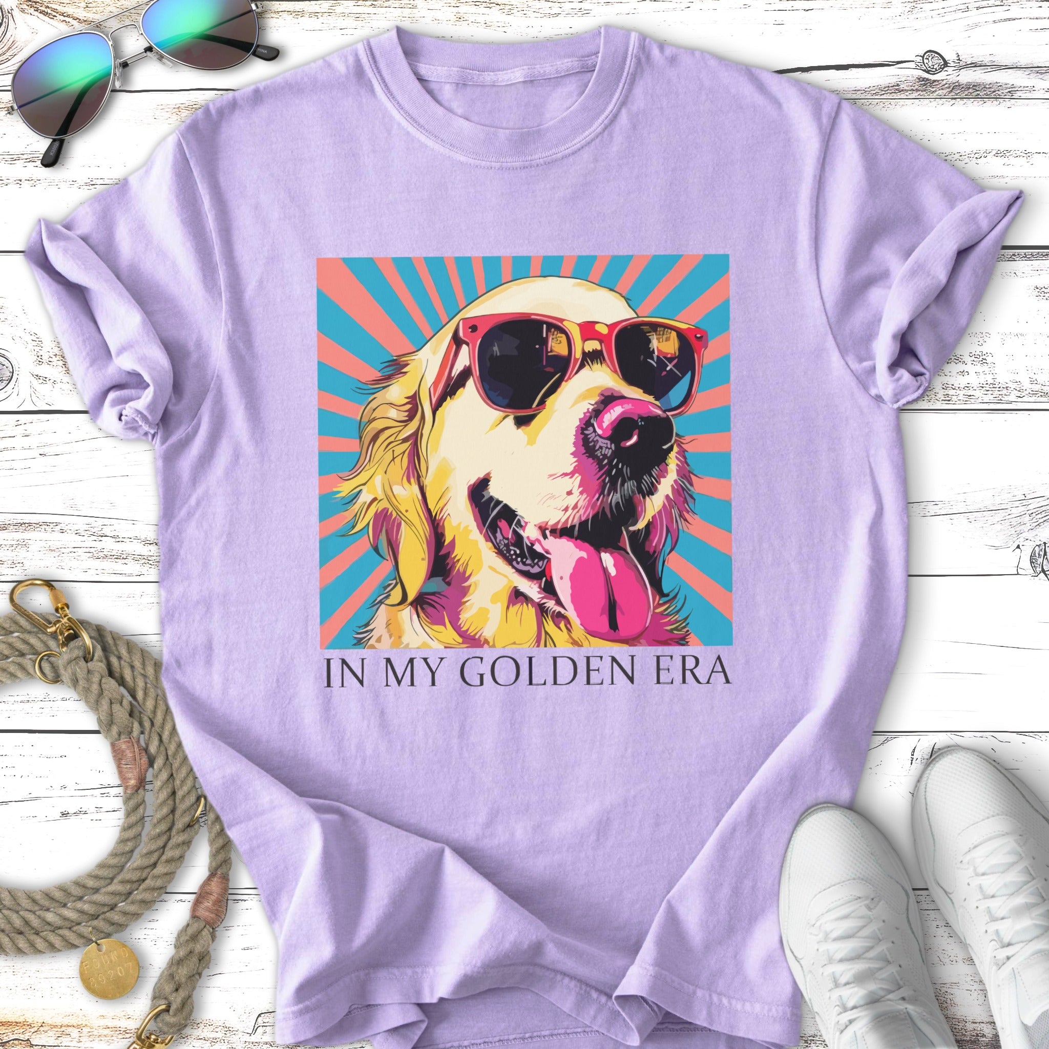 Golden Retriever wearing sunglasses against a colorful striped background, text reads "IN MY GOLDEN ERA".