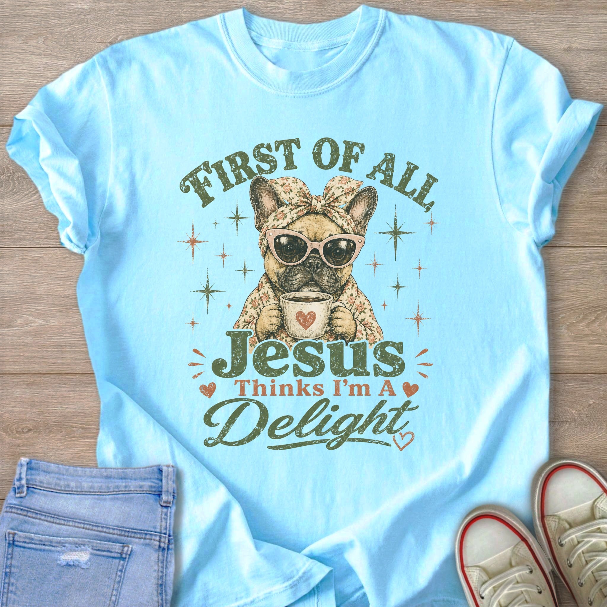 Light blue t-shirt with French bulldog graphic reading "First of all Jesus thinks I'm a delight".