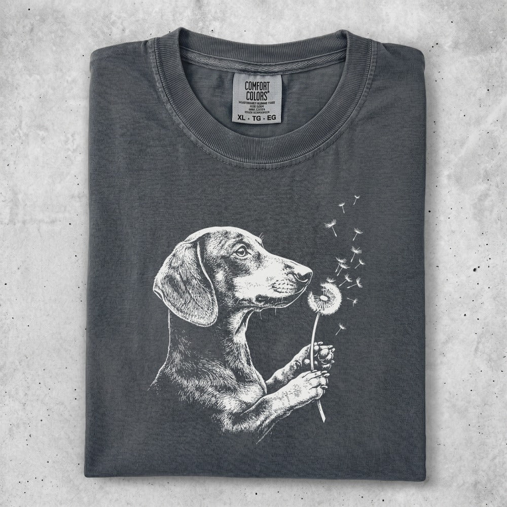 Charcoal t-shirt with a white line drawing of a dachshund holding a dandelion.