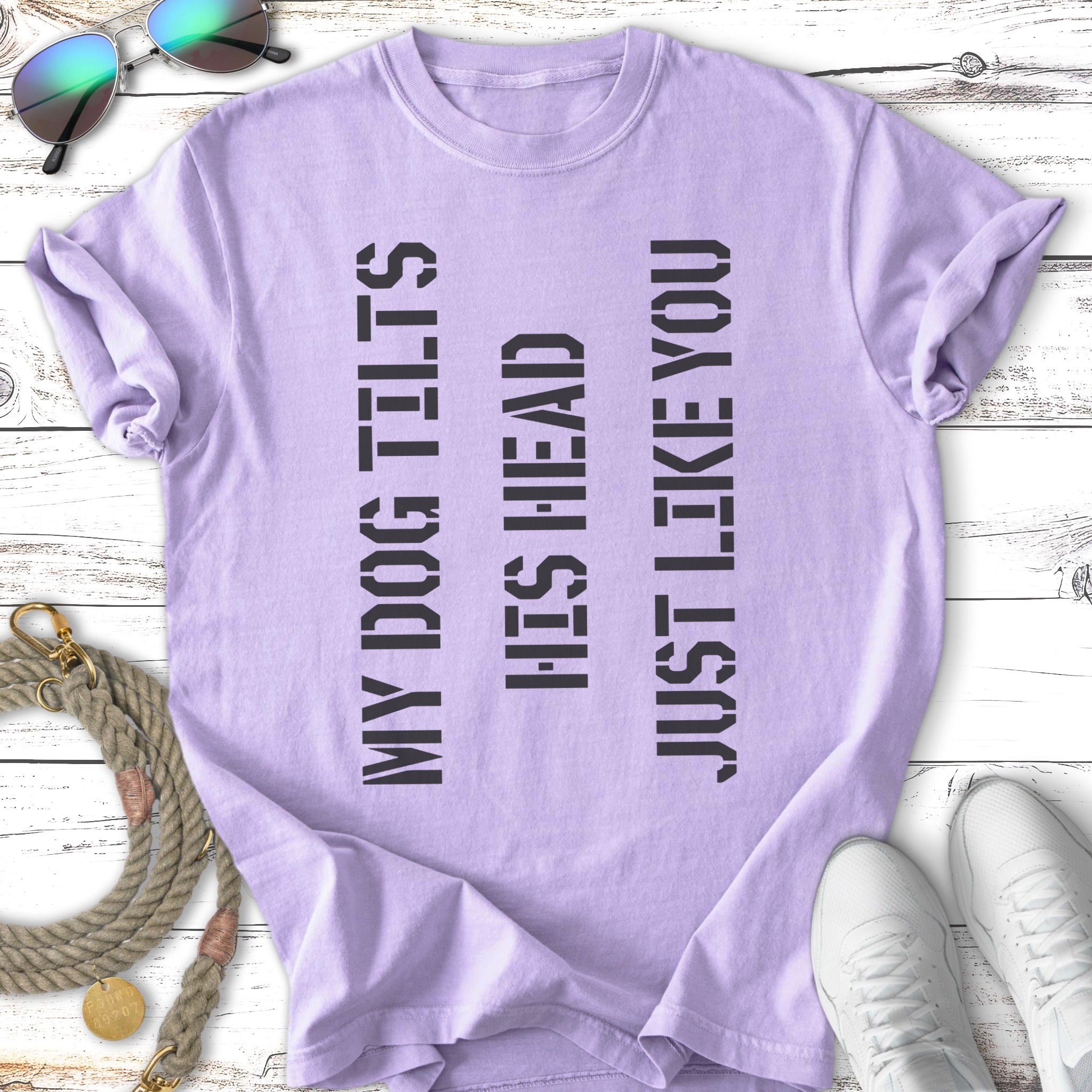 Purple t-shirt with black text reading "MY DOG TILTS HIS HEAD JUST LIKE YOU."