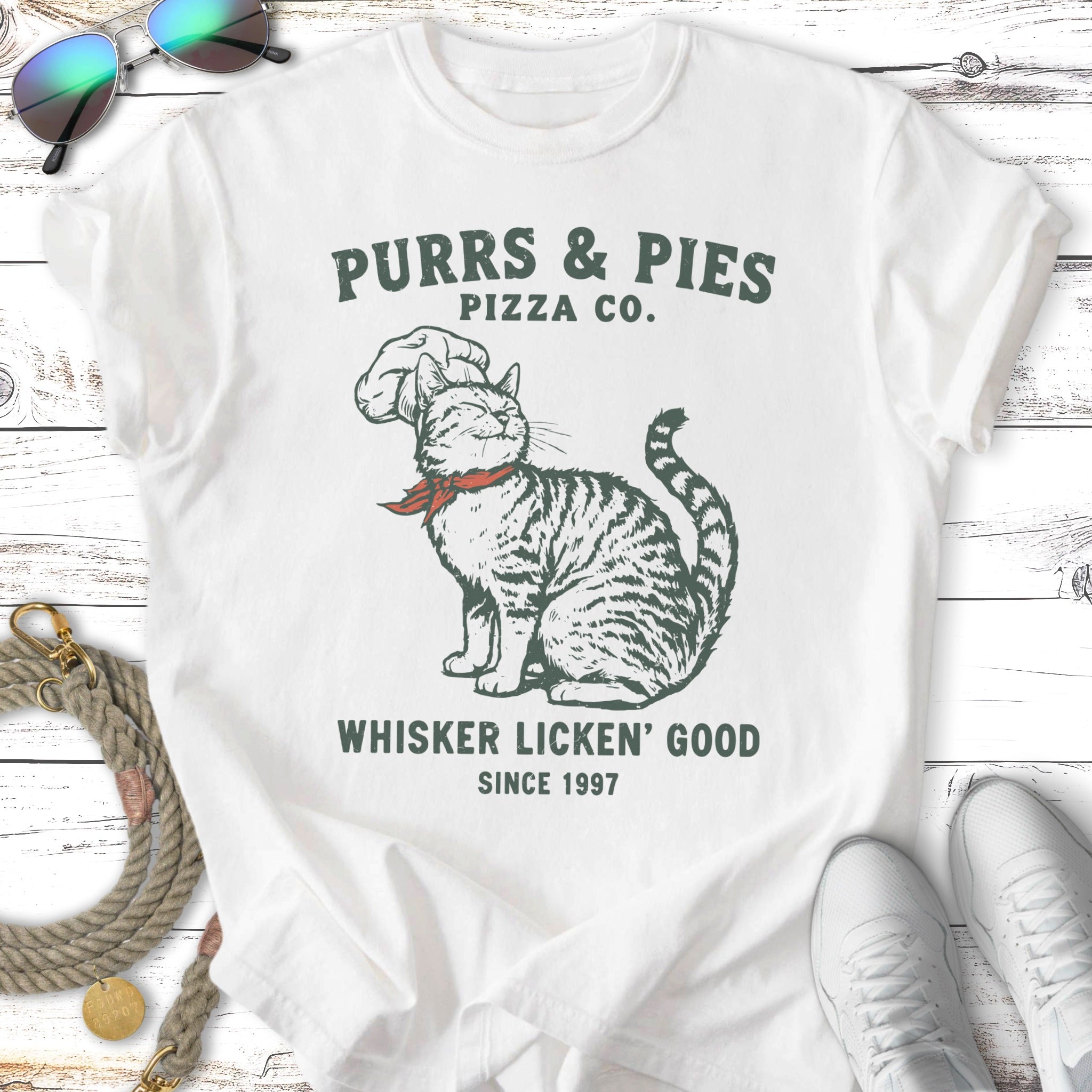 Purrs & Pies Pizza Co. cat wearing chef hat and bandana, "Whisker Licken' Good".