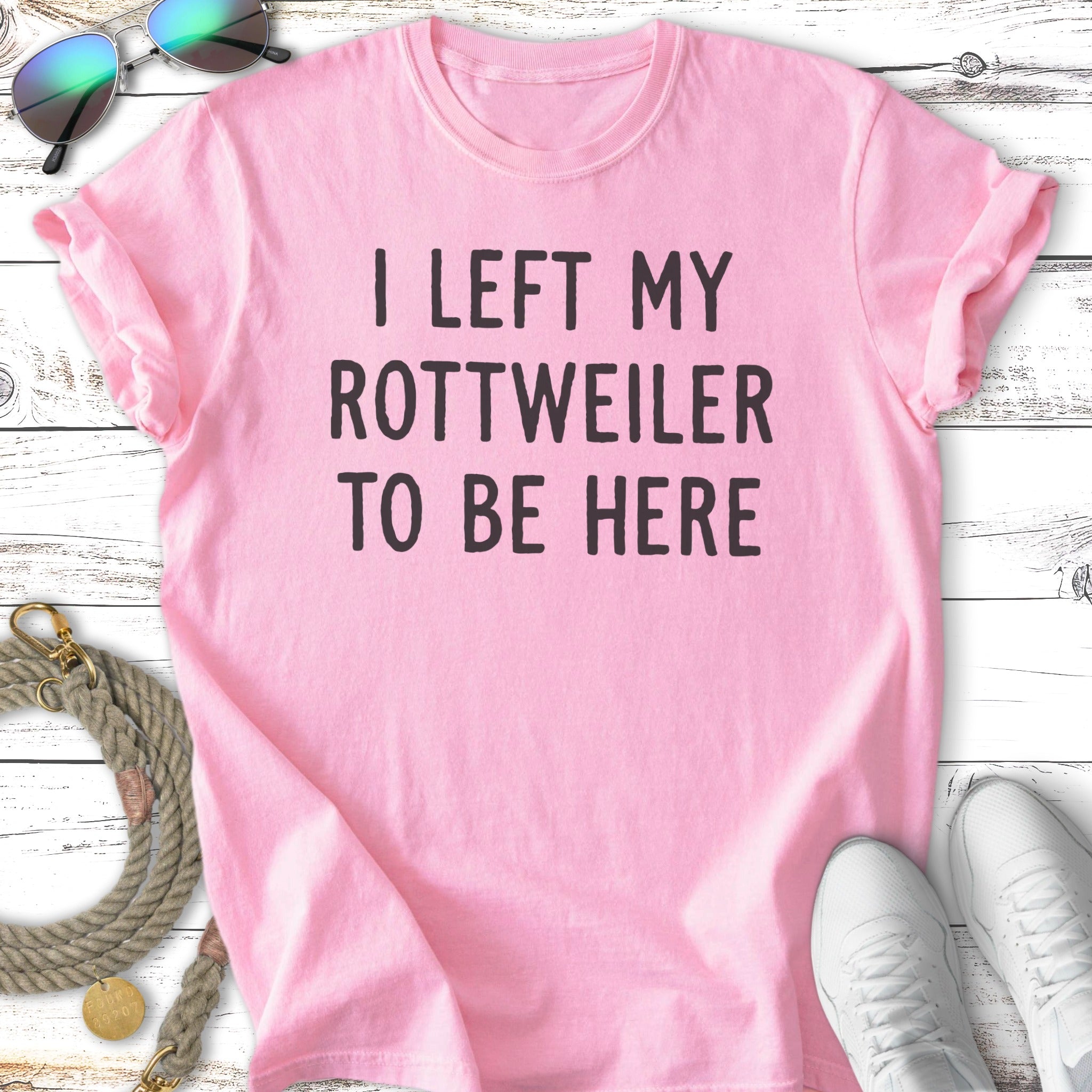 Pink t-shirt with "I left my Rottweiler to be here" text.