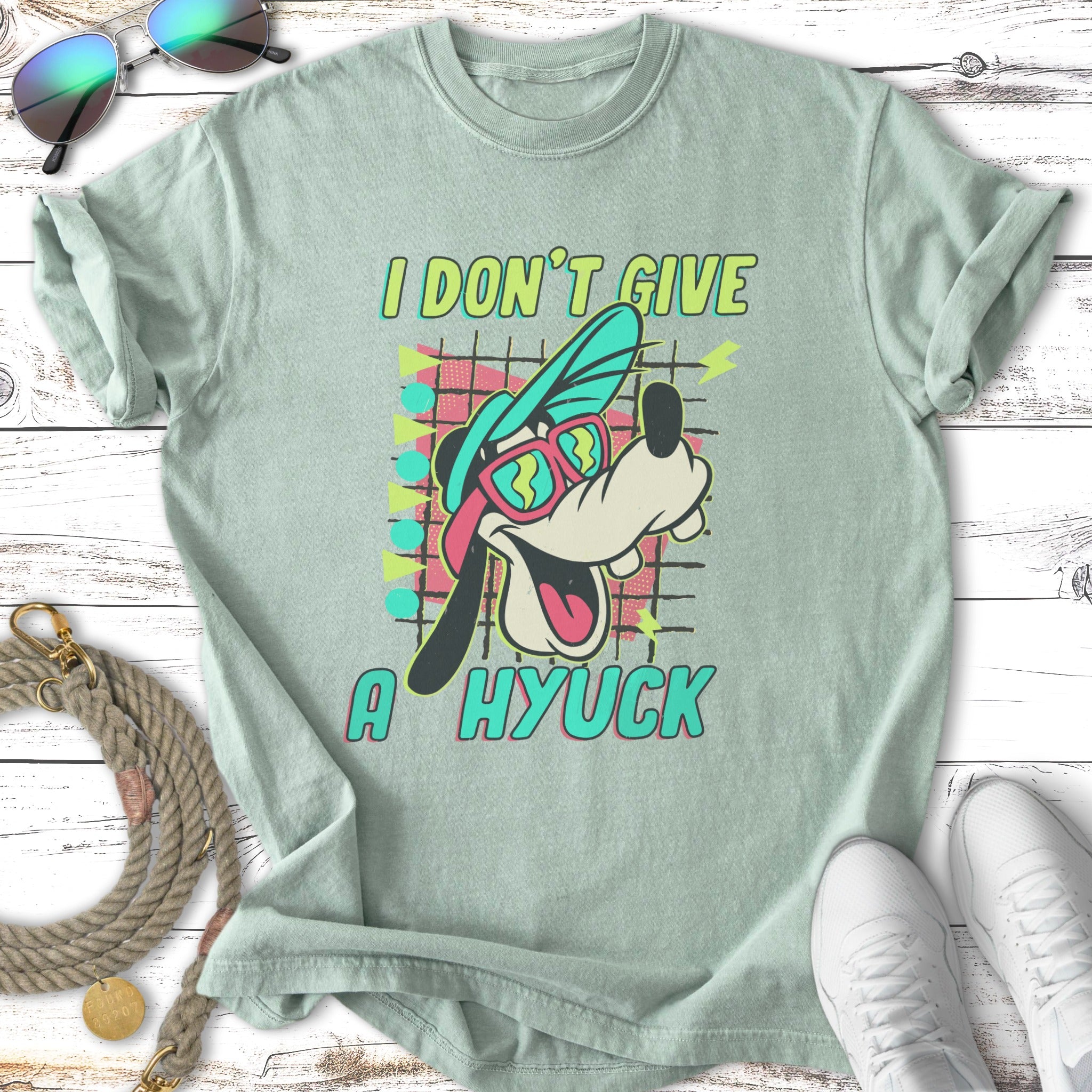 Goofy wearing sunglasses and a hat, text "I DON'T GIVE A HYUCK".