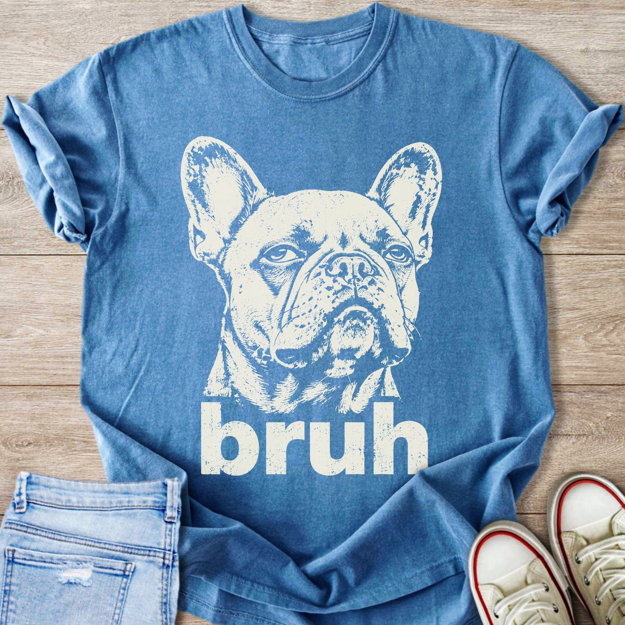 French bulldog graphic t-shirt with text "bruh" on a blue shirt.