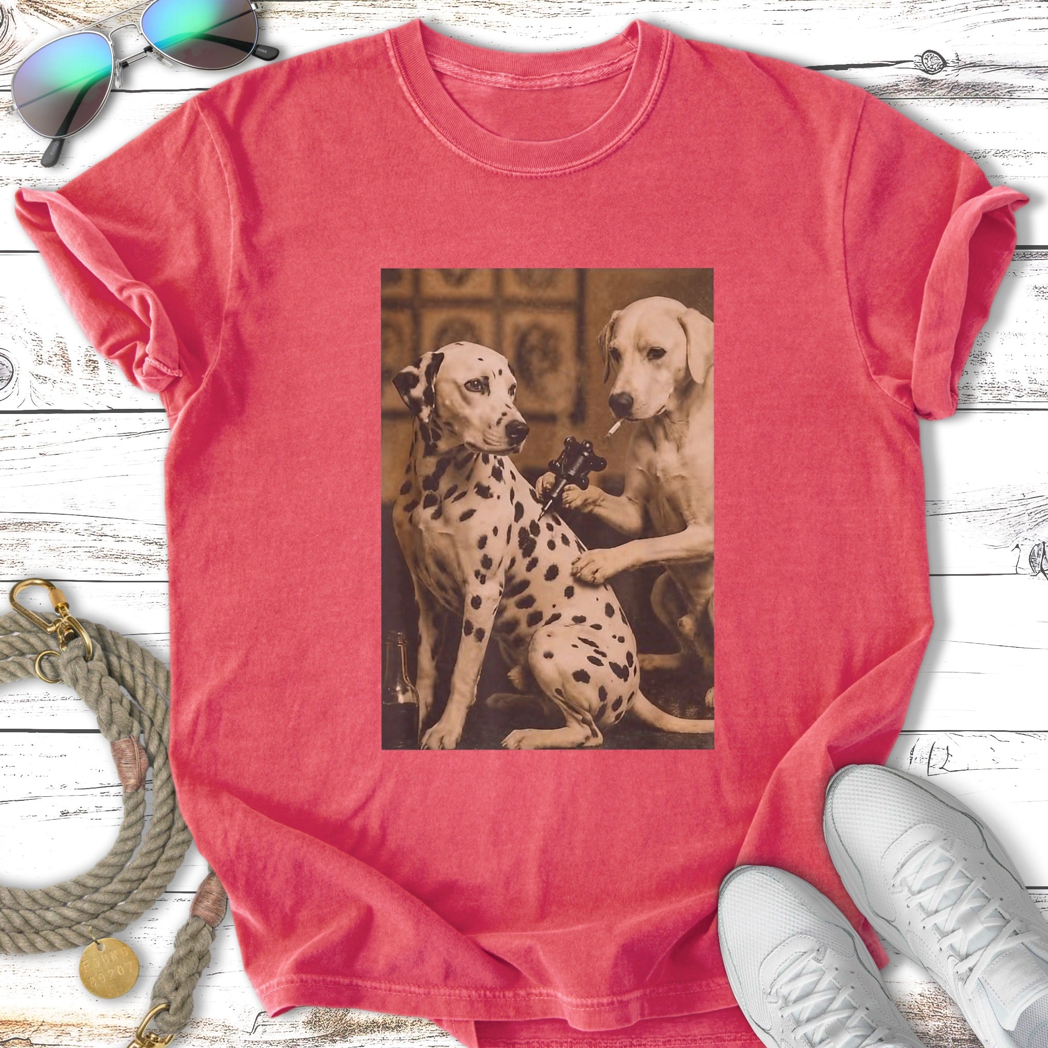 Dalmatians receiving tattoos on a distressed t-shirt.