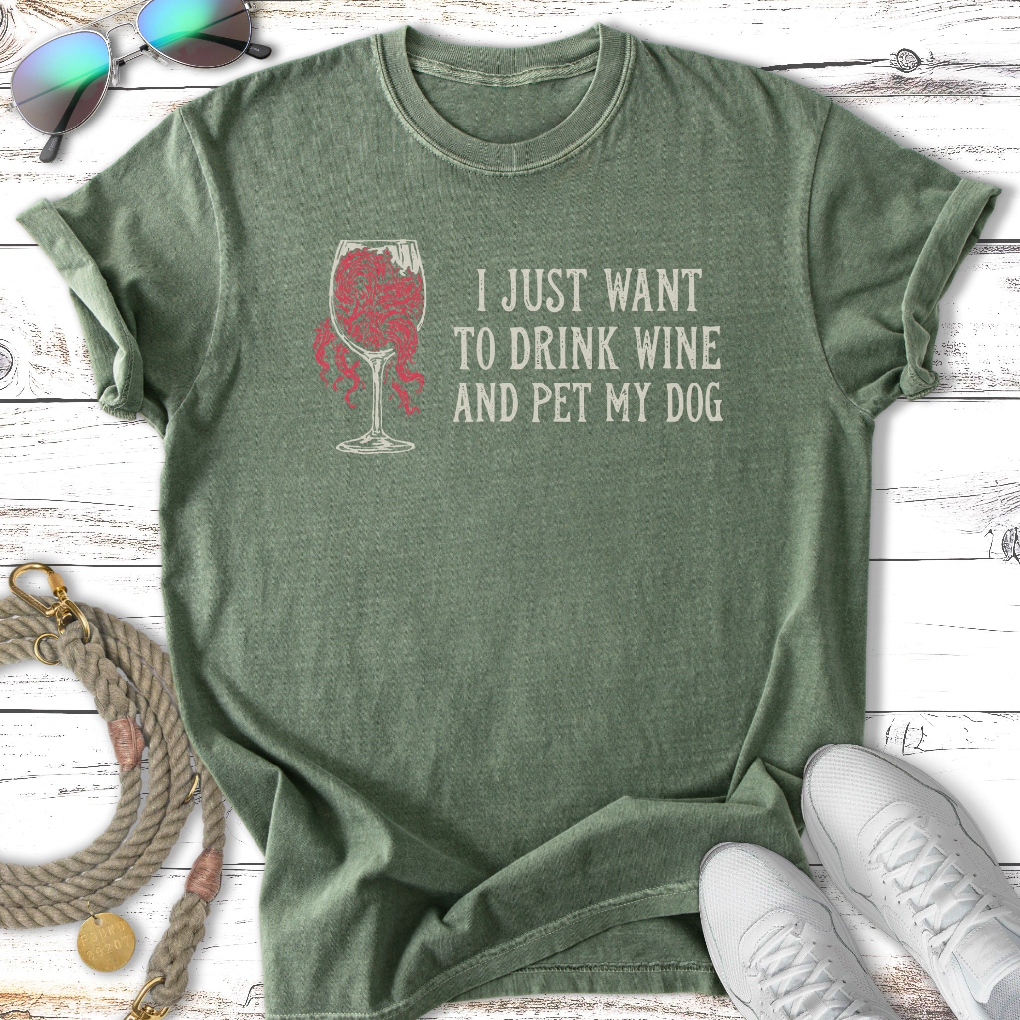 Green t-shirt with "I JUST WANT TO DRINK WINE AND PET MY DOG" text.