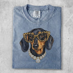 Dachshund wearing glasses and a diamond necklace.
