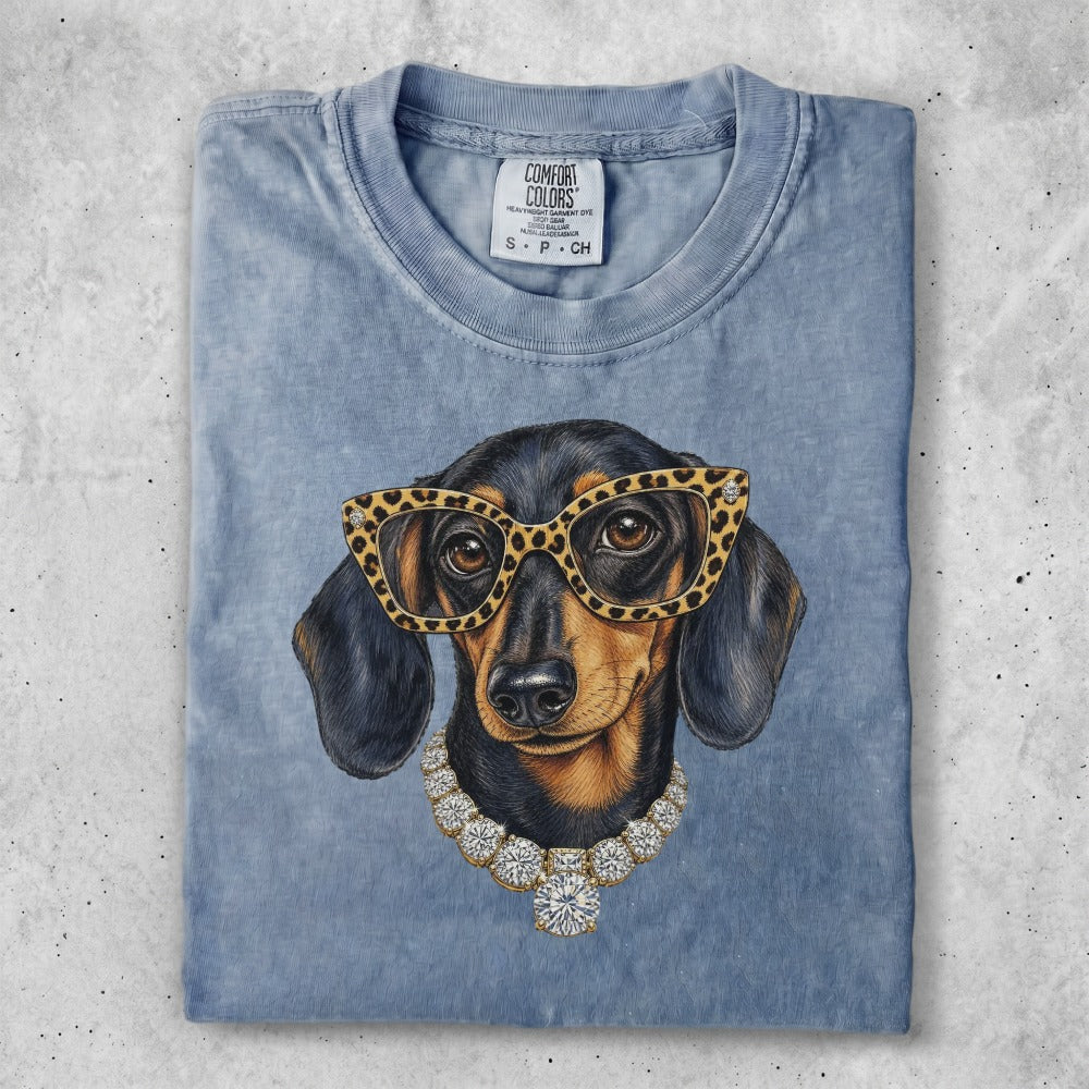 Dachshund wearing glasses and a diamond necklace.