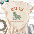 Cream t-shirt with "RELAX NOTHING IS UNDER CONTROL" text and illustration.