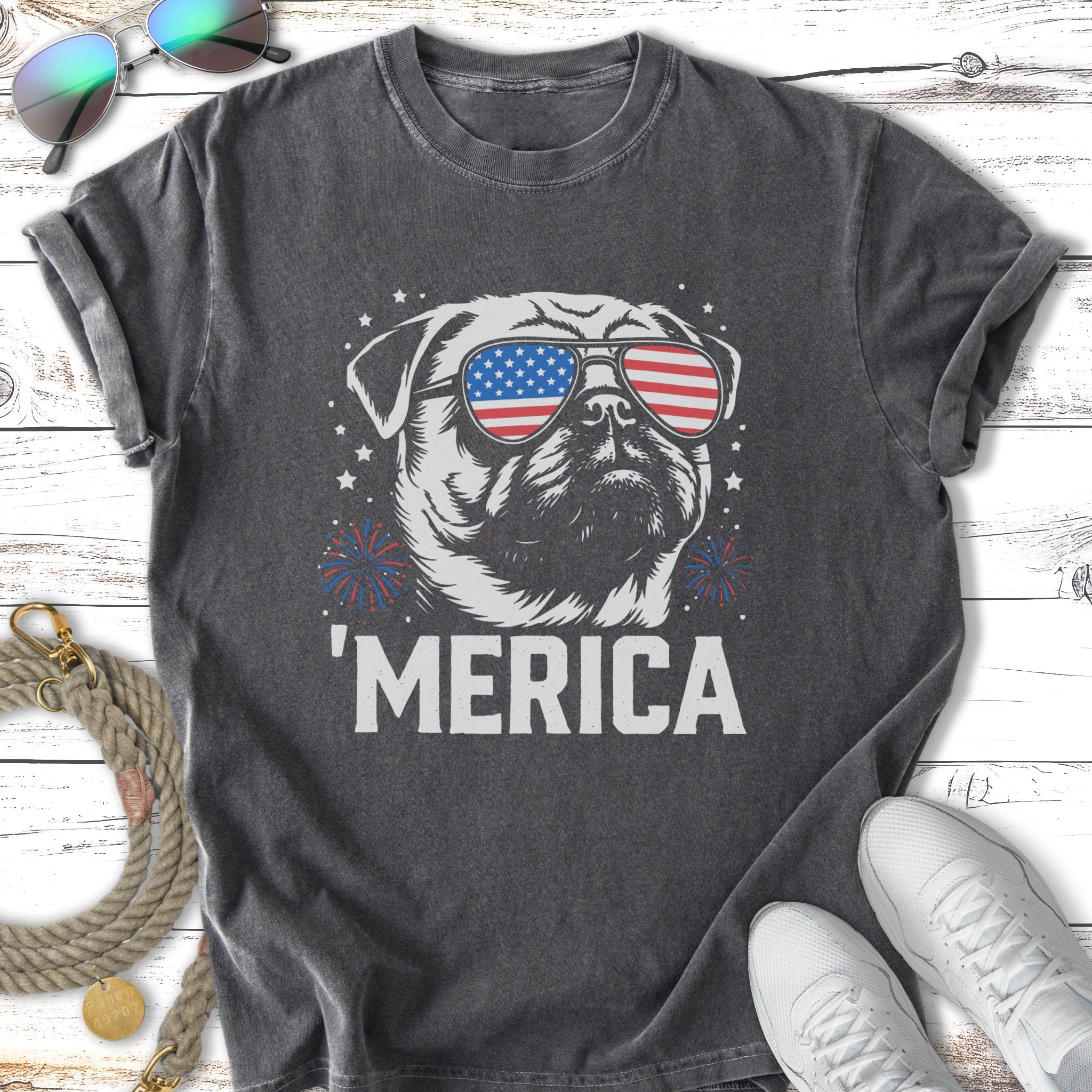 Pug wearing American flag sunglasses, "MERICA" text, fireworks.