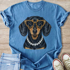 Blue t-shirt with a sequined dachshund wearing leopard print glasses and a diamond necklace.