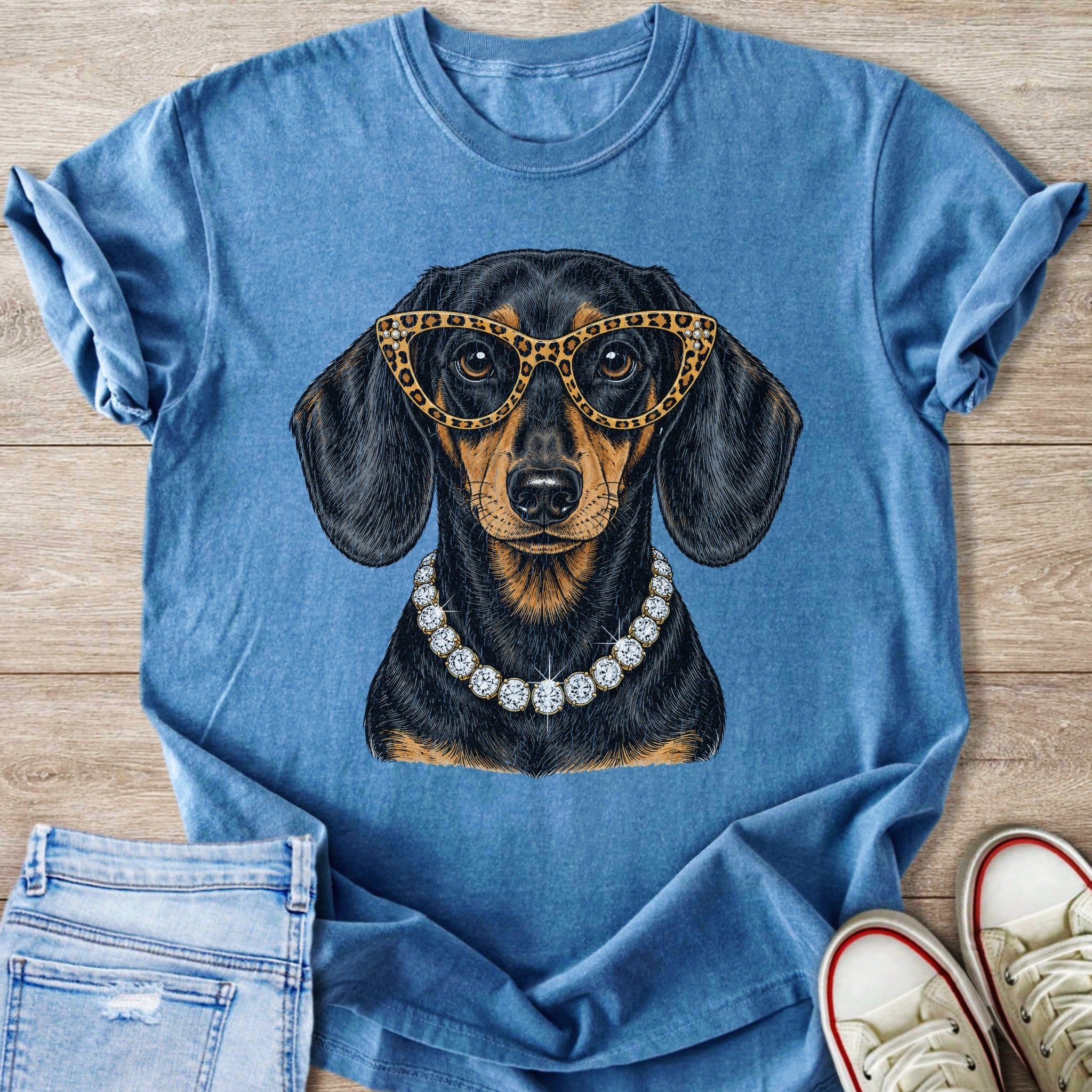 Blue t-shirt with a sequined dachshund wearing leopard print glasses and a diamond necklace.