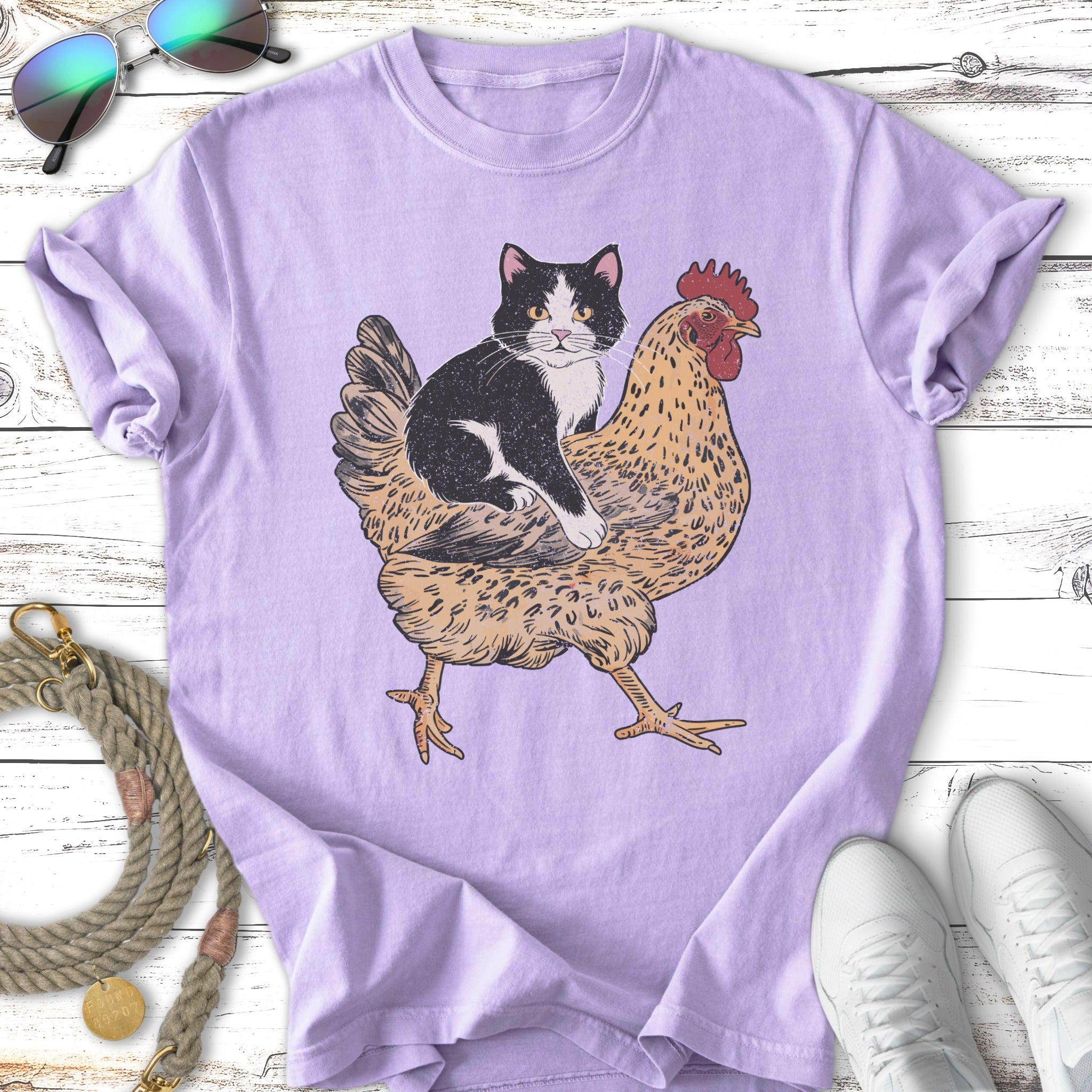 Black and white cat riding a chicken, with sunglasses and shoes.