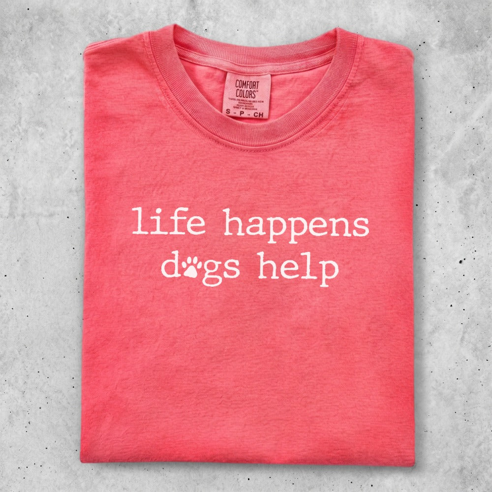 Coral t-shirt with "life happens dogs help" text in white.