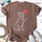French bulldog holding a red heart balloon on a brown t-shirt.