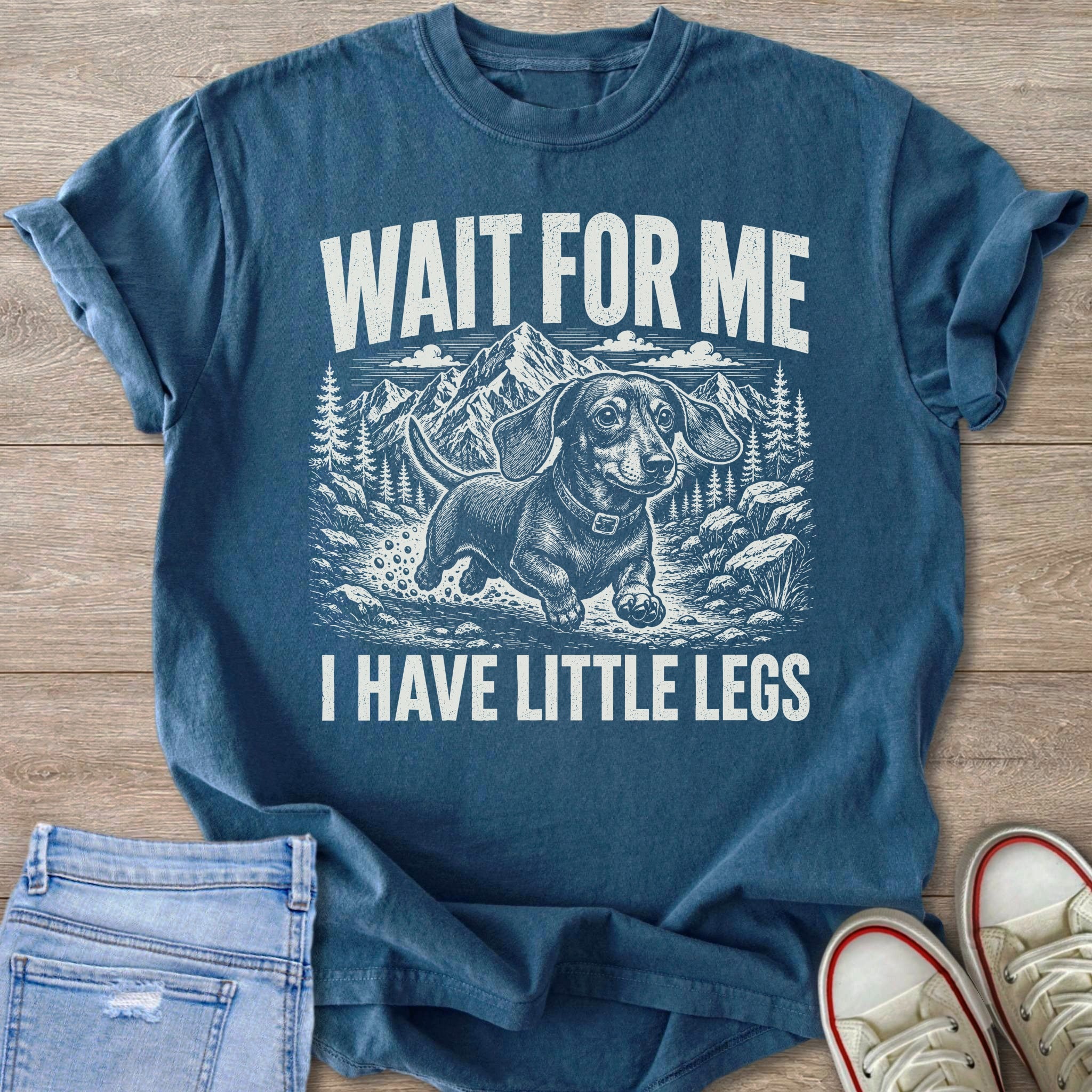 Dachshund with mountains and trees saying "Wait For Me I Have Little Legs."