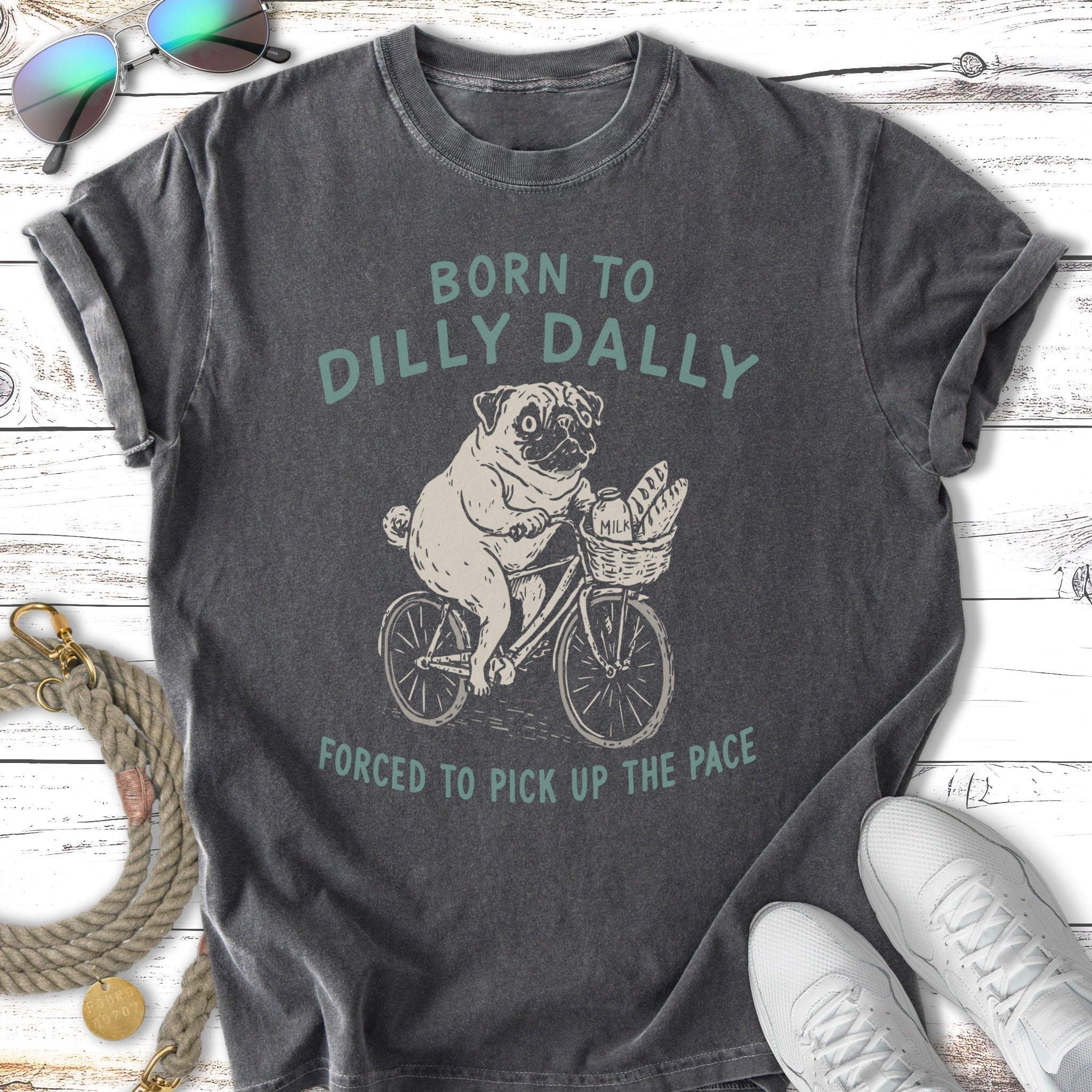 Pug on a bicycle with "Born to Dilly Dally" text, forced to pick up the pace.