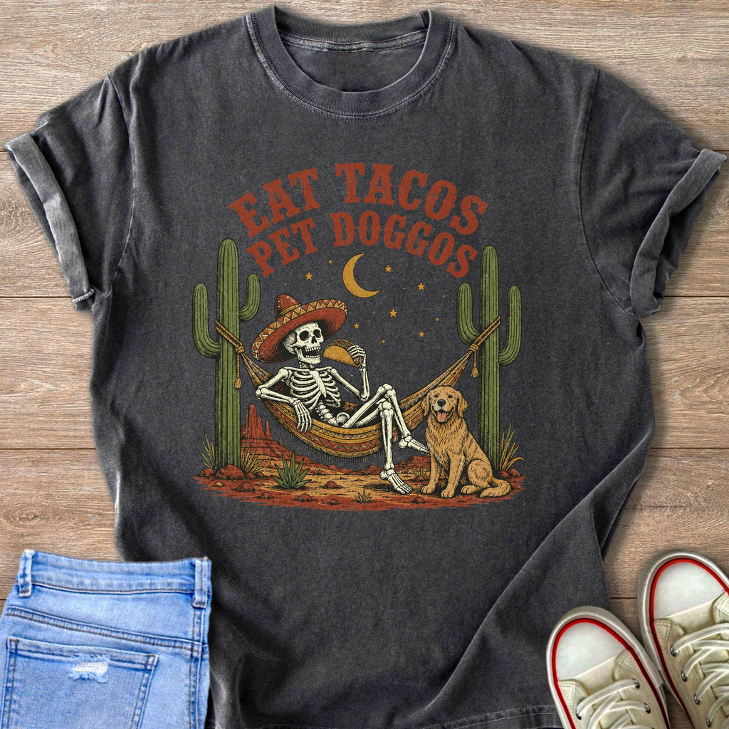 Skeleton in hammock eating taco with dog and cacti, text "EAT TACOS PET DOGGOS".