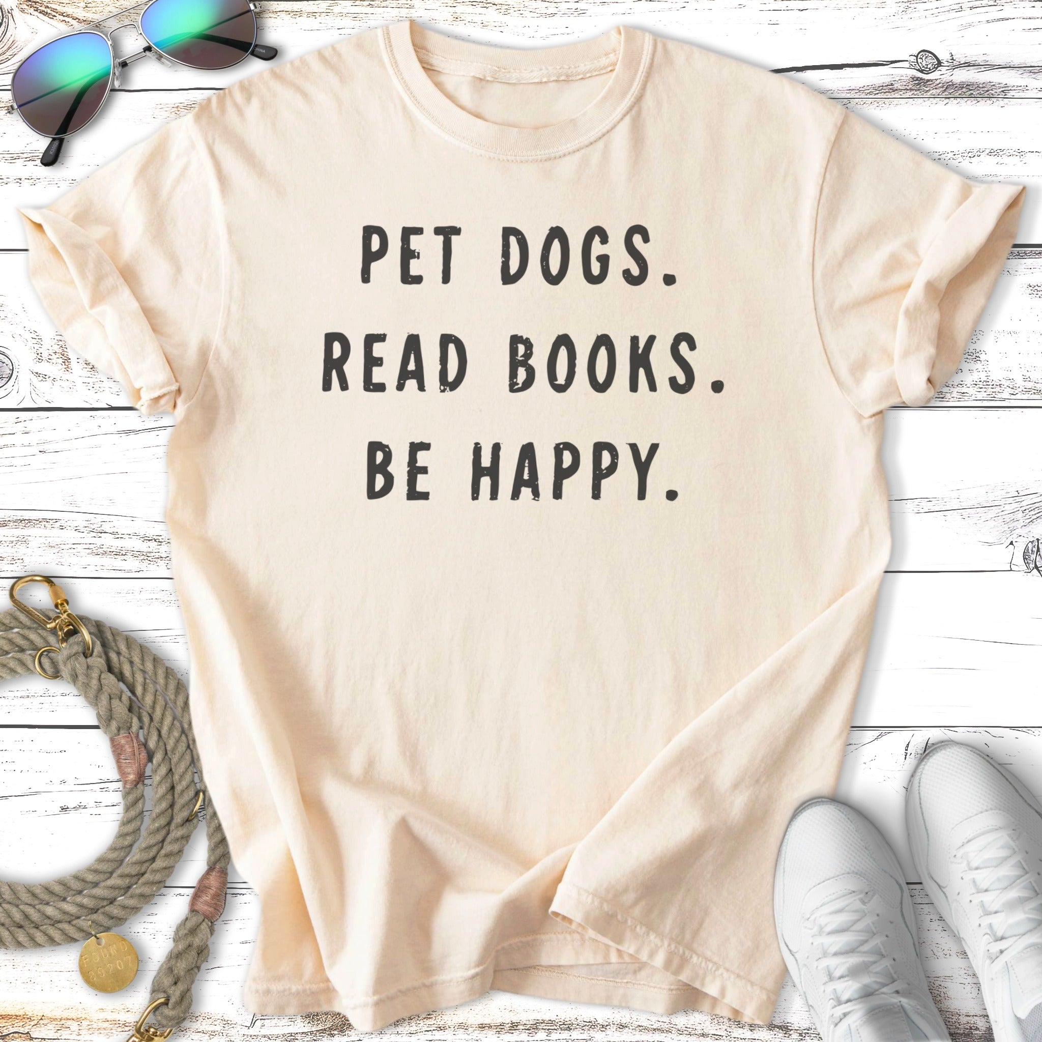 Cream t-shirt with "PET DOGS. READ BOOKS. BE HAPPY." text.