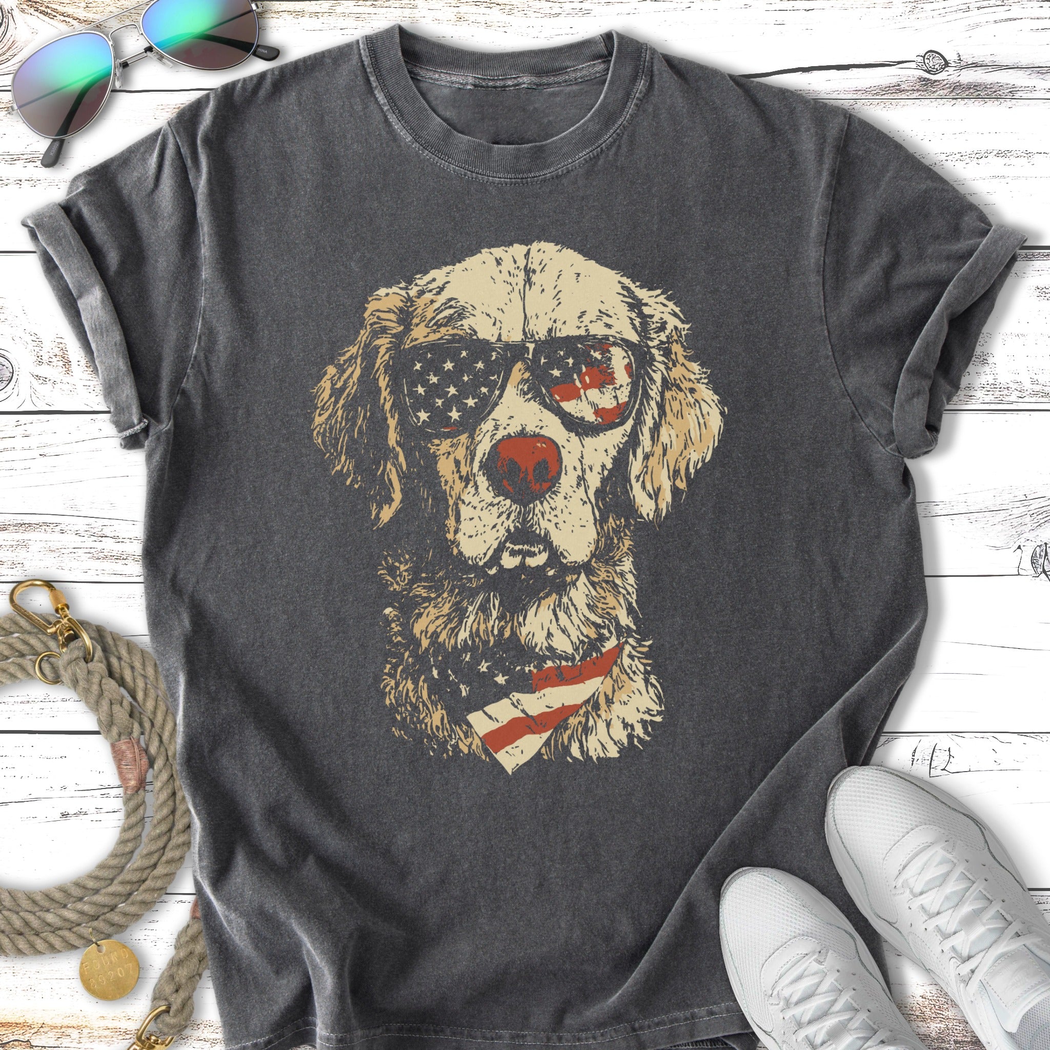 Golden Retriever wearing sunglasses and a bandana with American flag print.