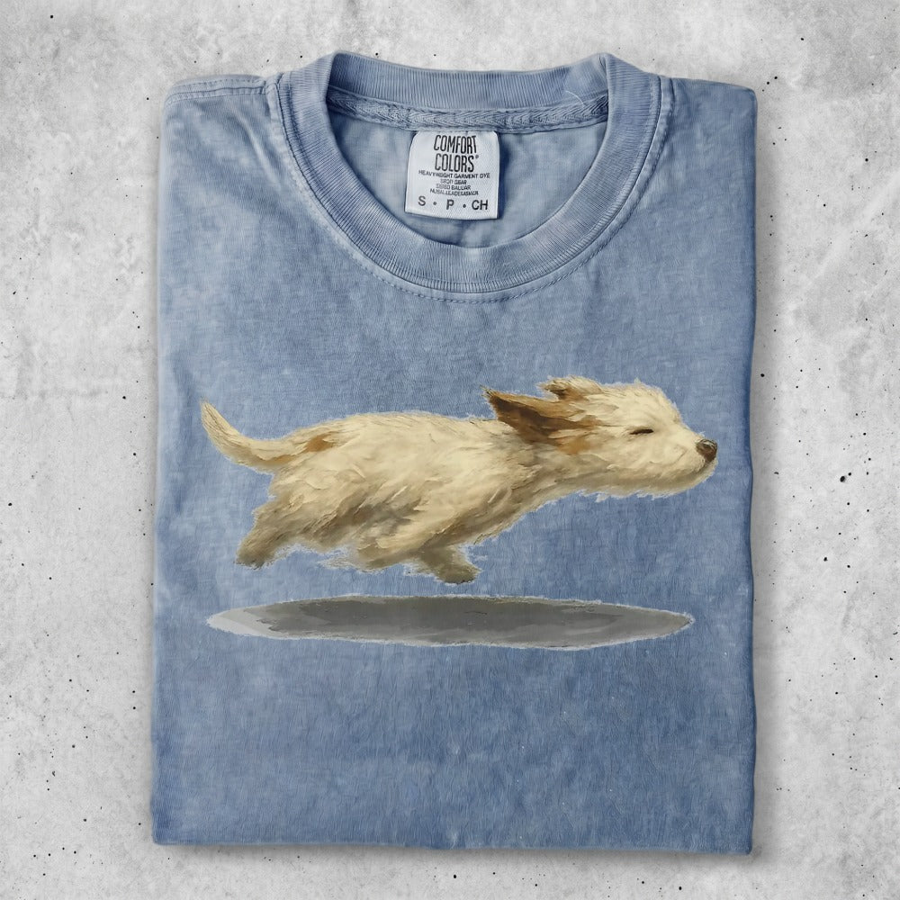 Light blue Comfort Colors t-shirt with a watercolor painting of a small tan dog running.