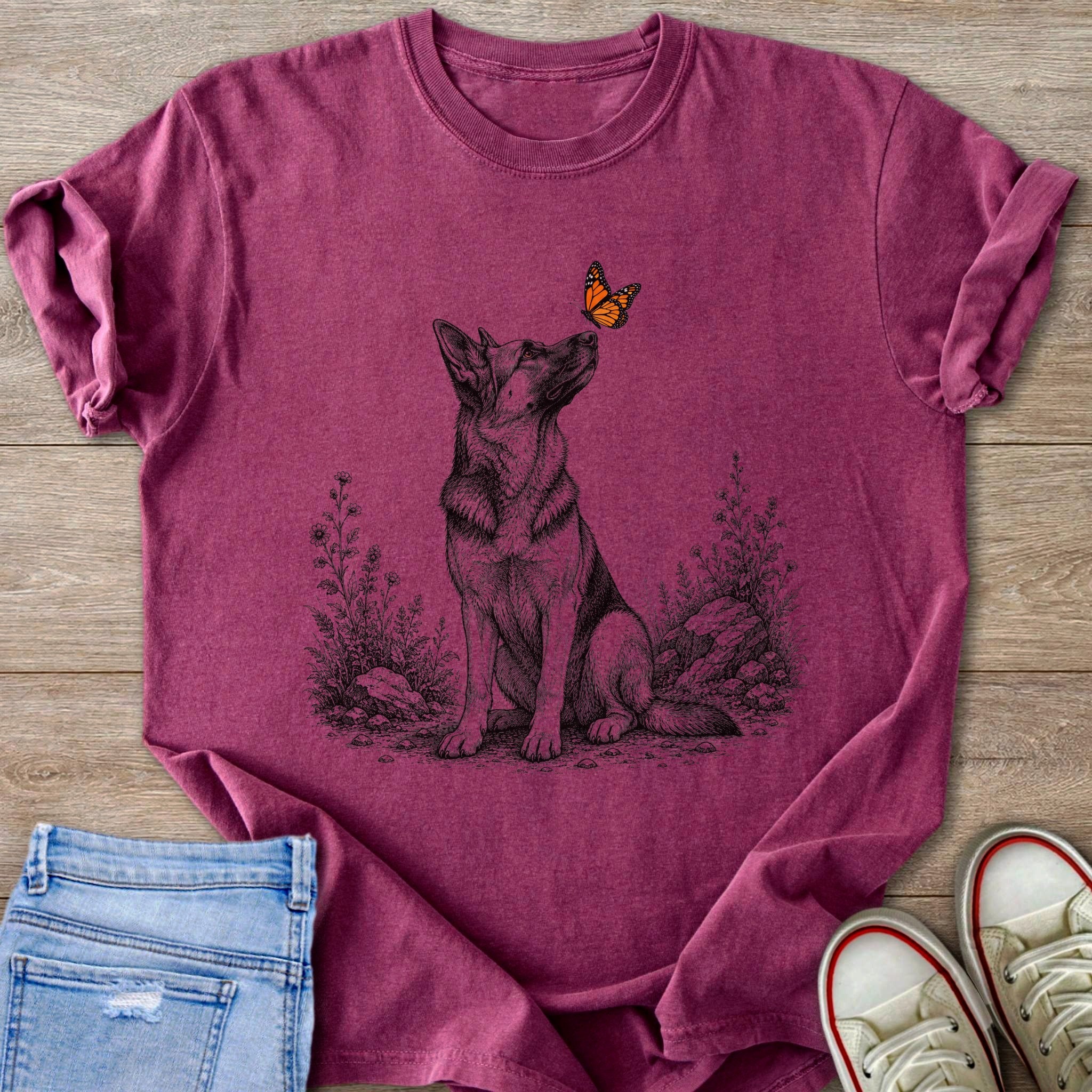 German Shepherd sitting with a butterfly on its nose, surrounded by plants.