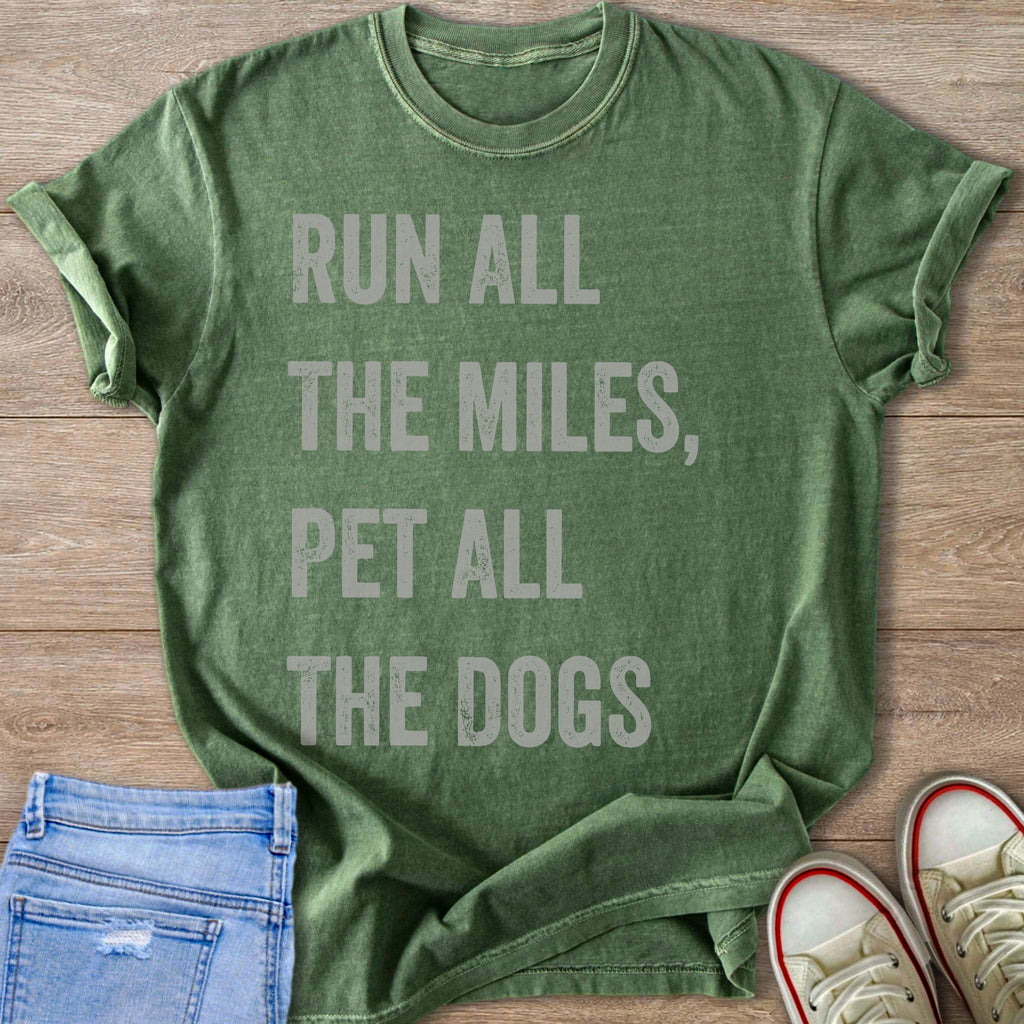 Green t-shirt with gray text reading "RUN ALL THE MILES, PET ALL THE DOGS".