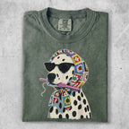 Dalmatian wearing sunglasses and a crochet scarf, holding a crochet hook.