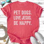 Coral t-shirt with "PET DOGS. LOVE JESUS. BE HAPPY." text.
