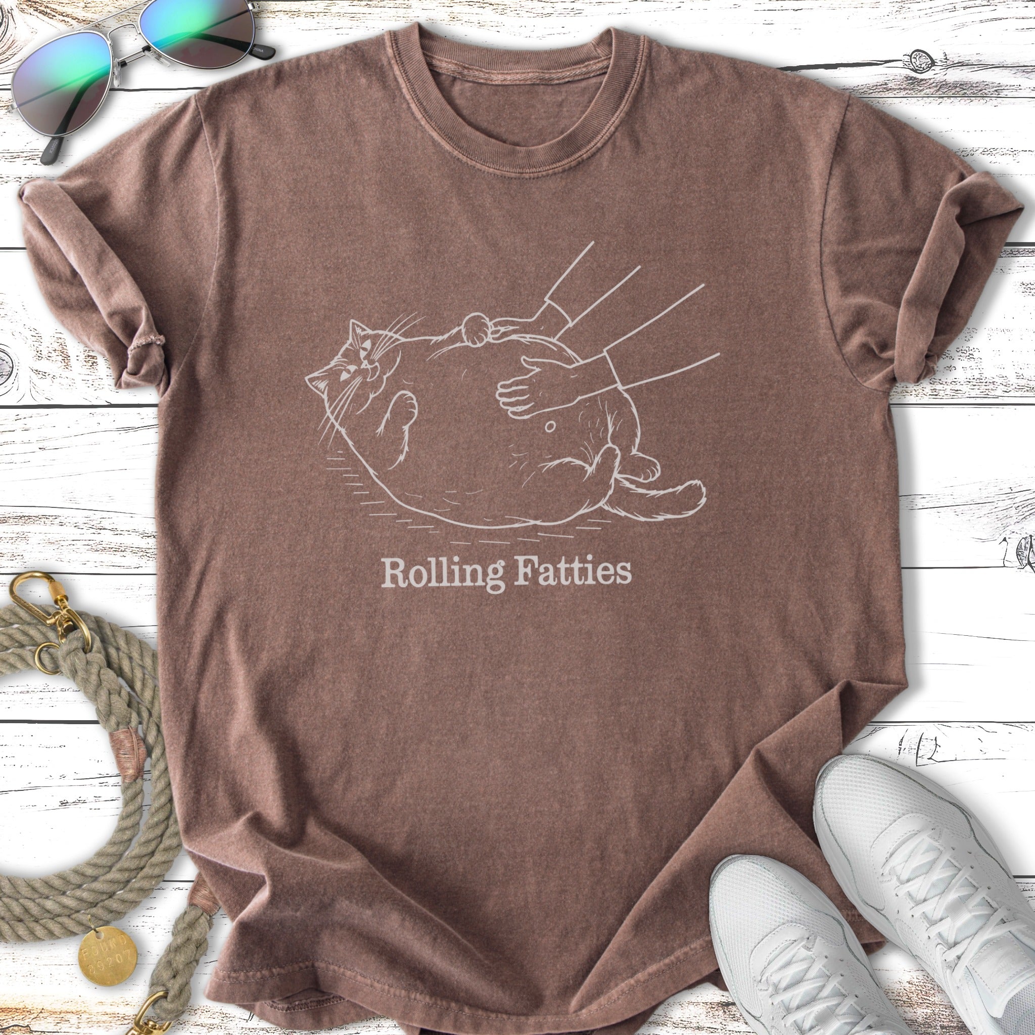 Brown t-shirt with a line drawing of a cat being petted, text reads "Rolling Fatties".