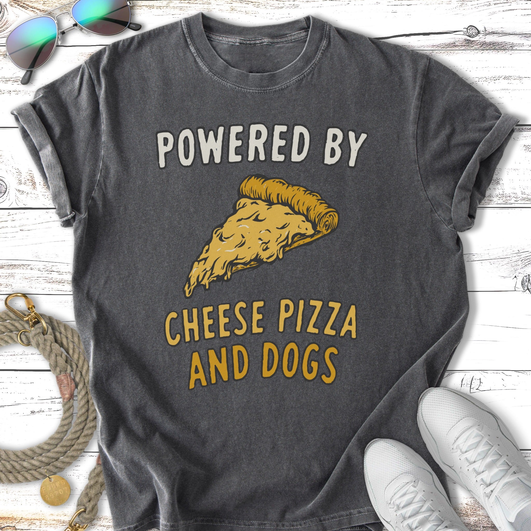 Dark t-shirt with "POWERED BY CHEESE PIZZA AND DOGS" and a slice of pizza.