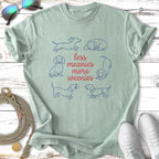 Light green t-shirt with dachshund illustrations and text "less meanies more weenies".