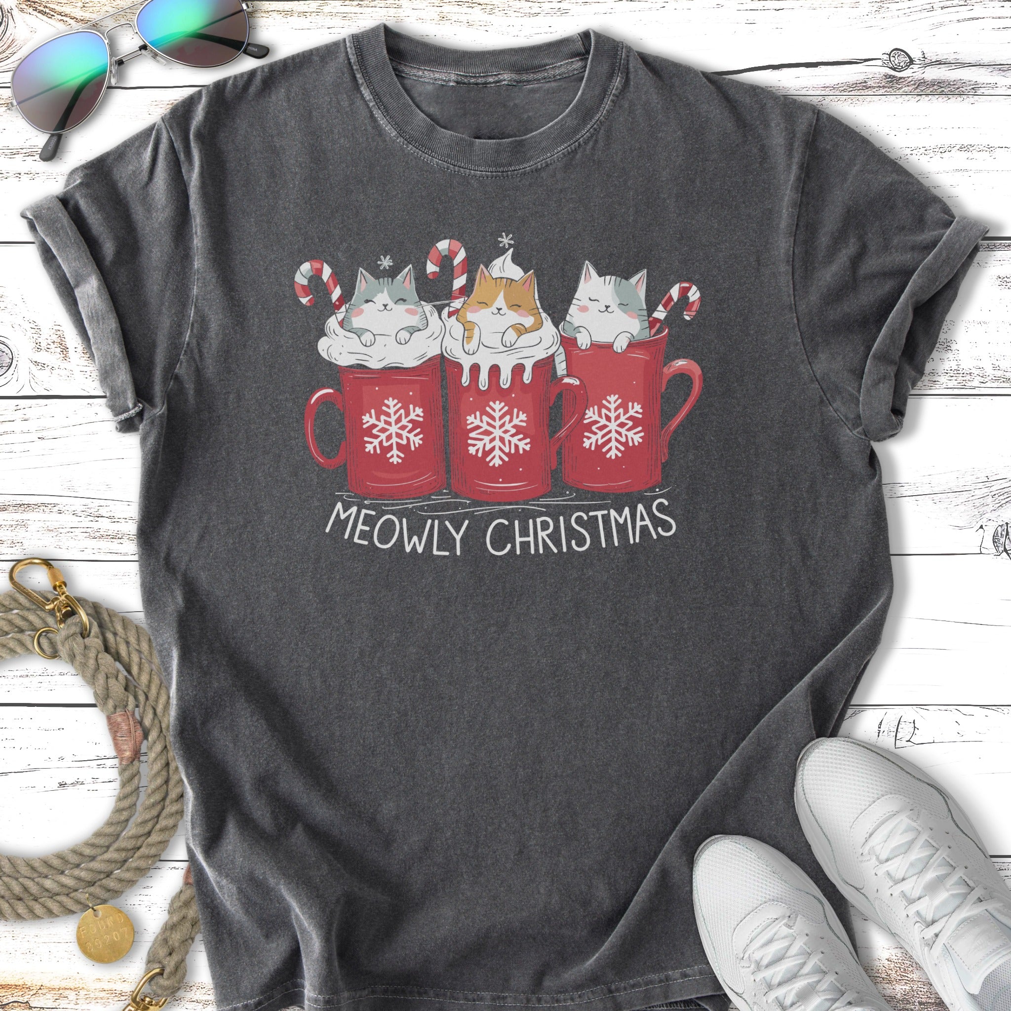 Three kittens in red mugs with candy canes and snowflakes, text says "MEOWLY CHRISTMAS."