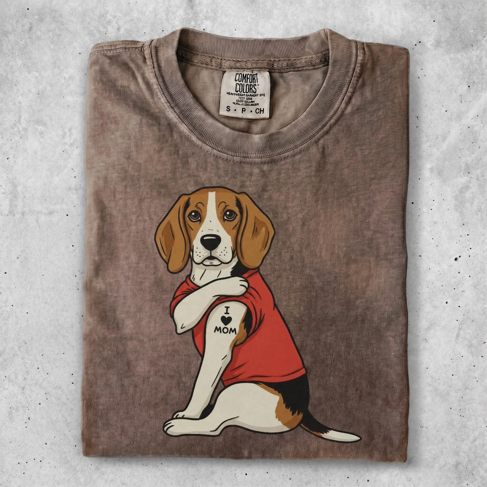 Beagle dog wearing a red shirt with an "I Love Mom" tattoo.