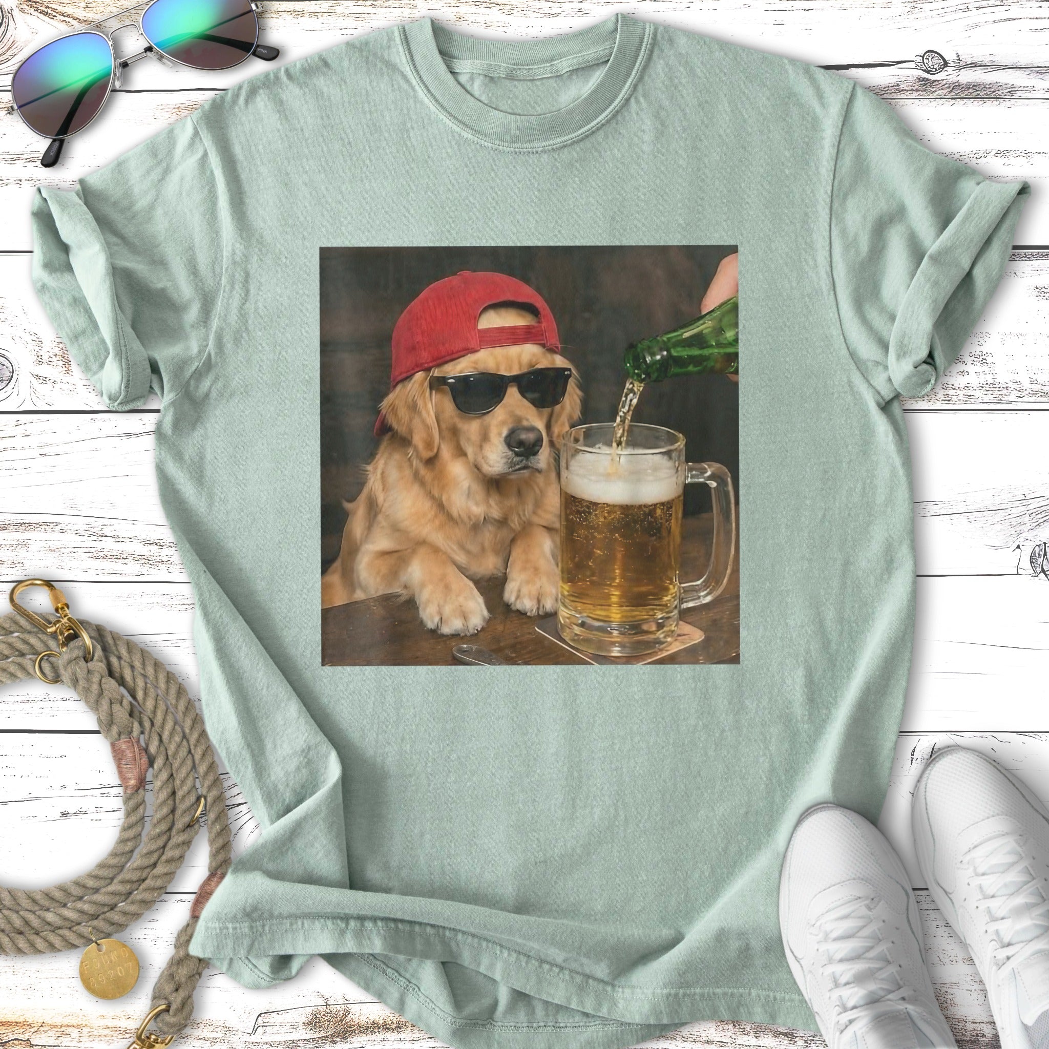 Golden retriever dog in a red cap and sunglasses pours beer into a mug.