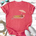 Cartoon hot dog with sunglasses relaxes under an umbrella on a beach.