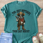 Boston Terrier cowboy holding a gun with text "YOU JUST BUTTERED YOUR LAST BISCUIT".