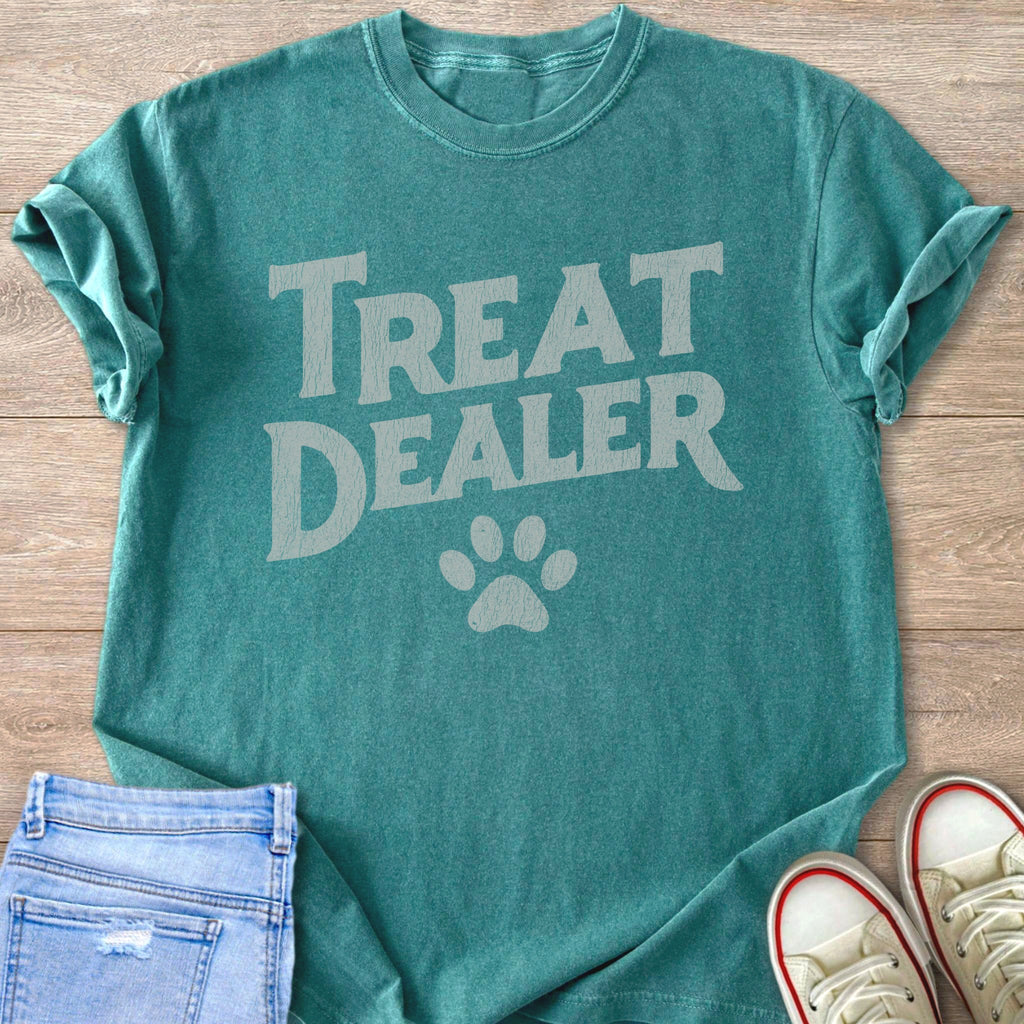 Teal t-shirt with "Treat Dealer" text and paw print graphic.
