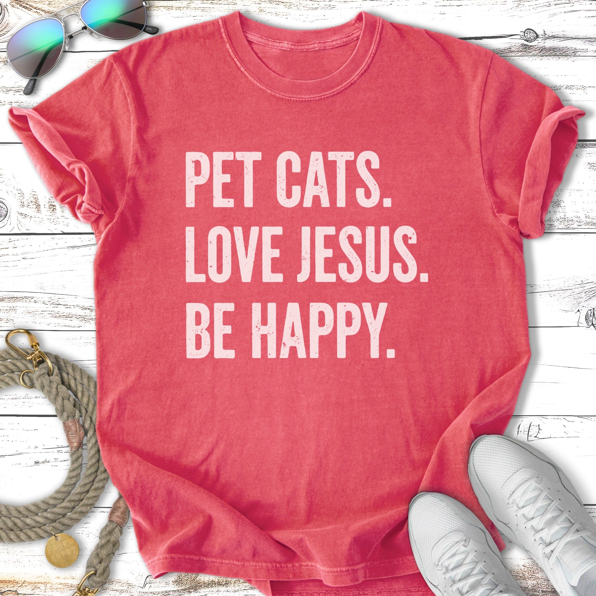 Red t-shirt with "Pet Cats. Love Jesus. Be Happy." text.