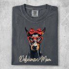 Doberman Mom t-shirt with heart glasses and red bow.